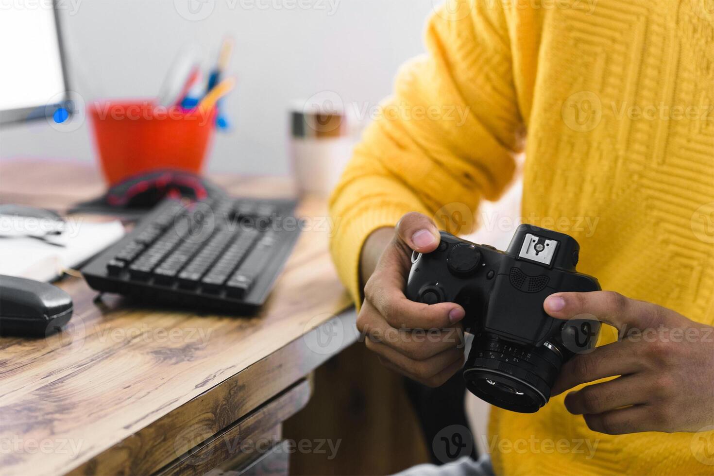 unrecognizable person holding a camera with hands. photo