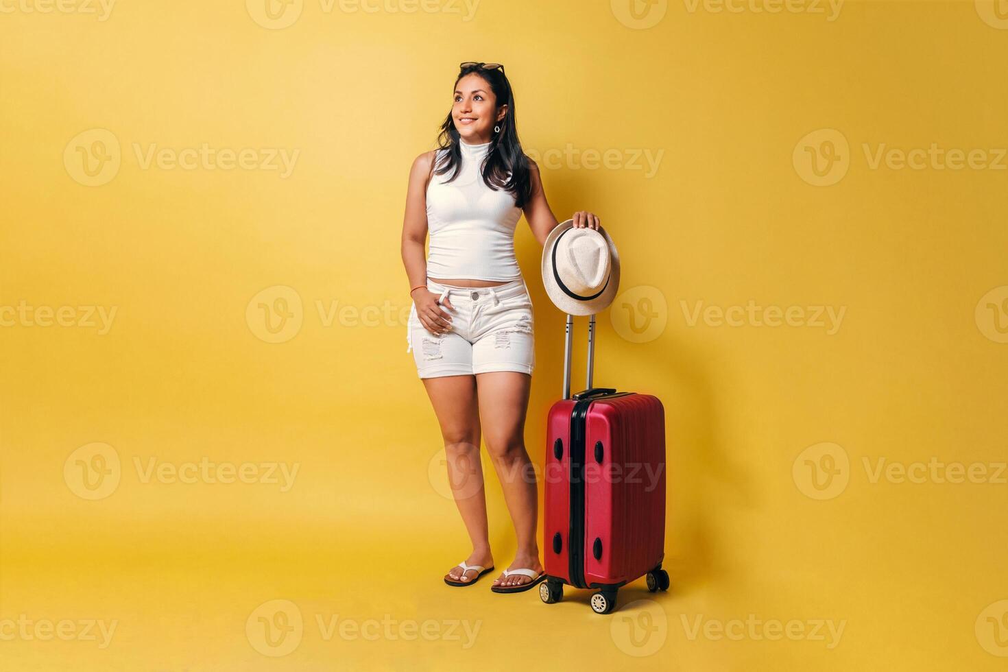 Hispanic traveler woman holding a baggage, holidays concept. photo
