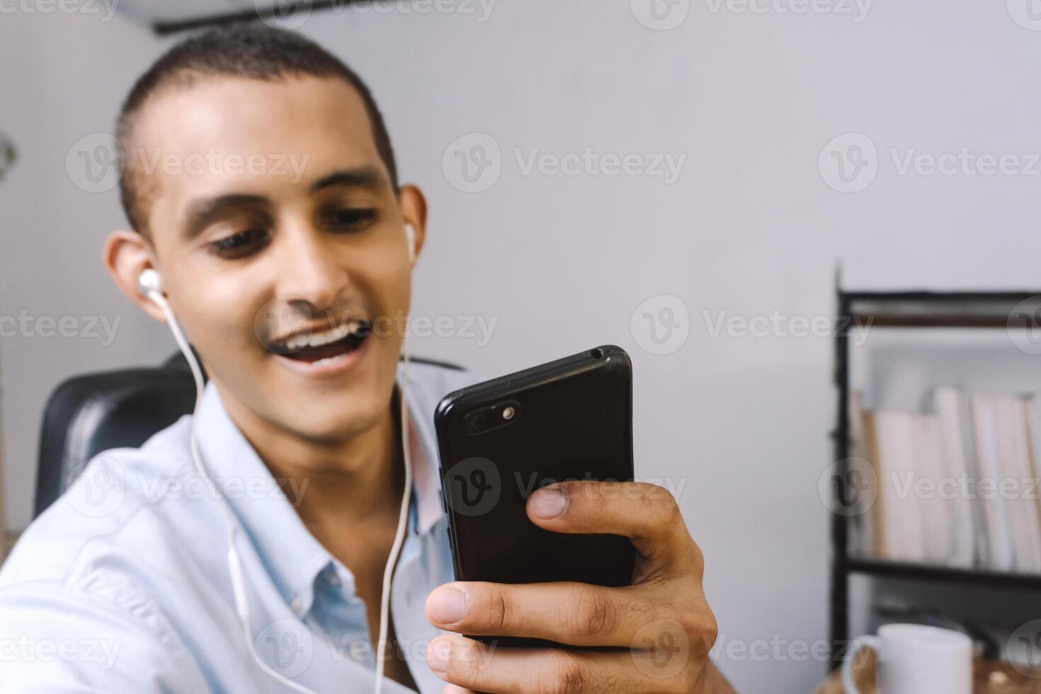 portrait of a young latinx using a mobile smart phone. technology concept. photo