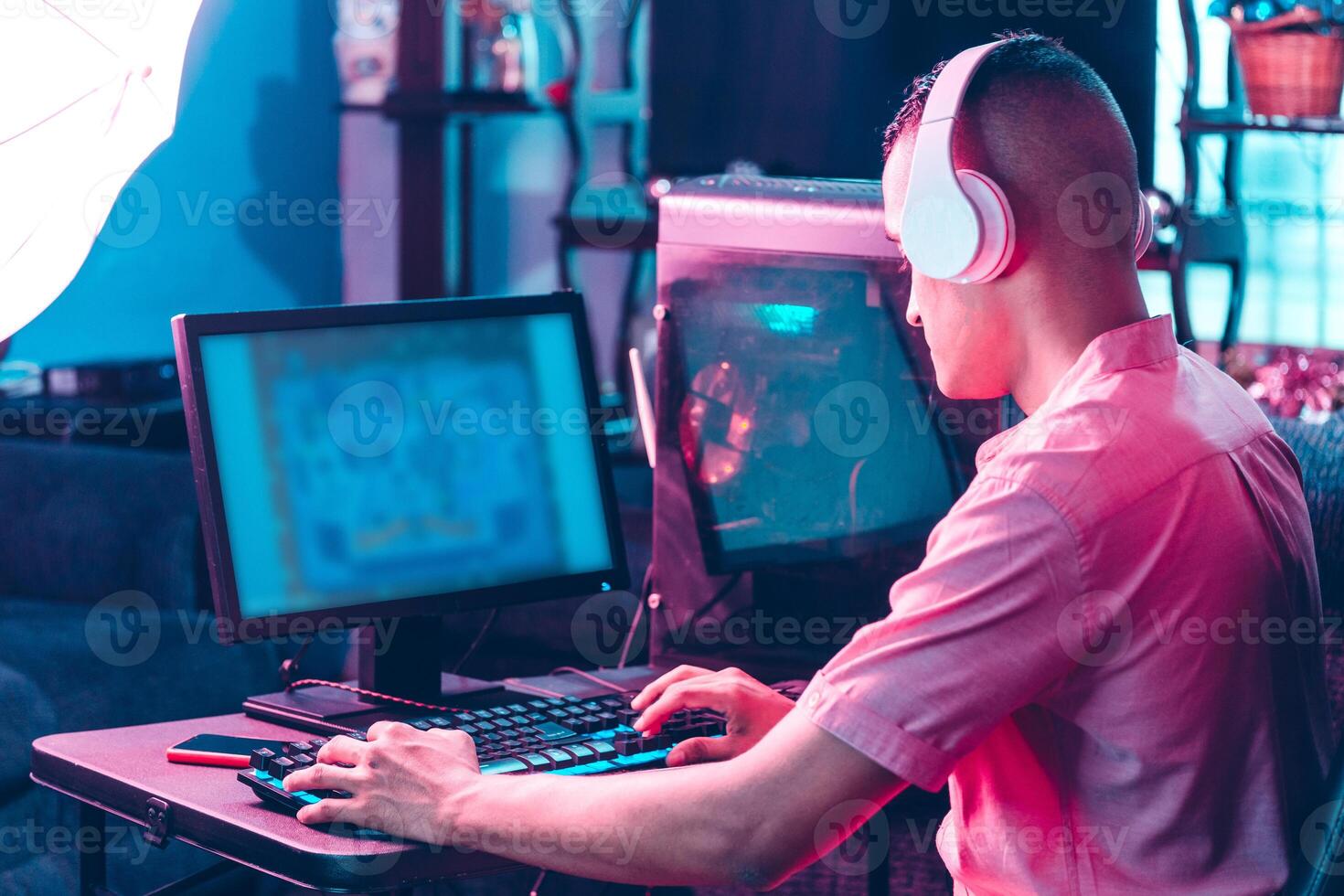 back man of gamer man playing on a computer. photo