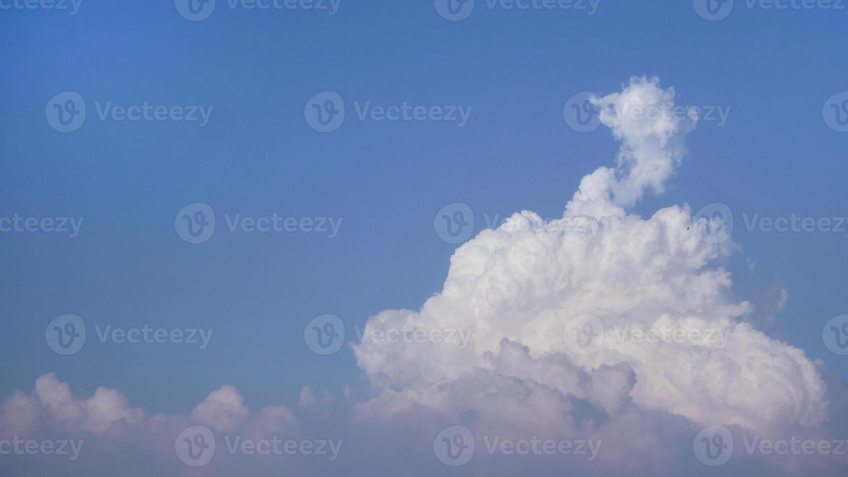 White fluffy clouds open for fantasy idea shape against bright blue sky for background with copy space, graphic resource, cloud motion from the wind photo