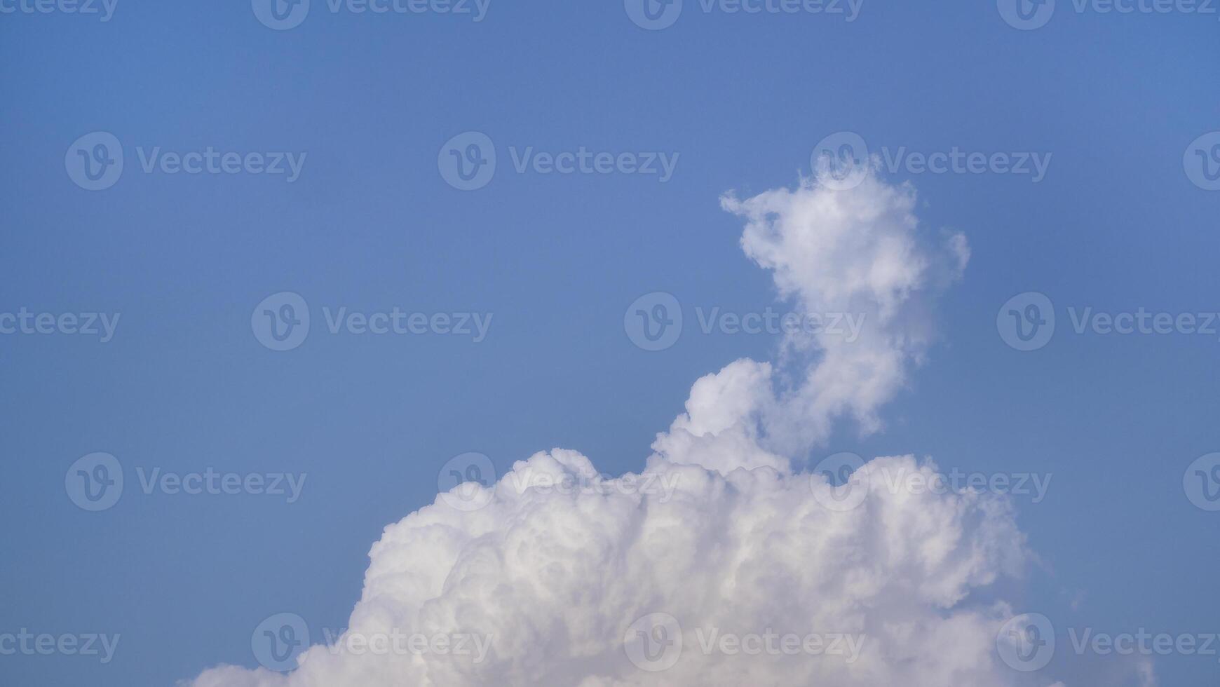White fluffy clouds open for fantasy idea shape against bright blue sky for background with copy space, graphic resource, cloud motion from the wind photo