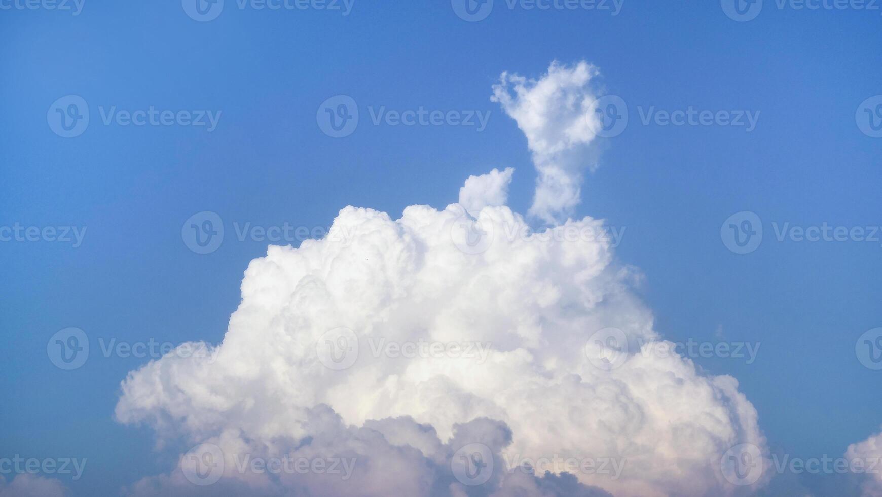 White fluffy clouds open for fantasy idea shape against bright blue sky for background with copy space, graphic resource, cloud motion from the wind photo