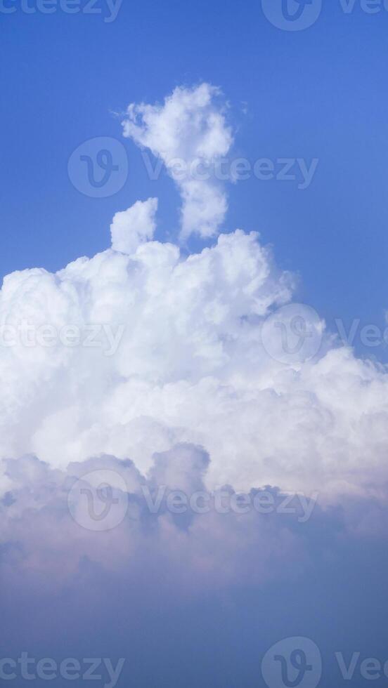 White fluffy clouds open for fantasy idea shape against bright blue sky for background with copy space, graphic resource, cloud motion from the wind photo