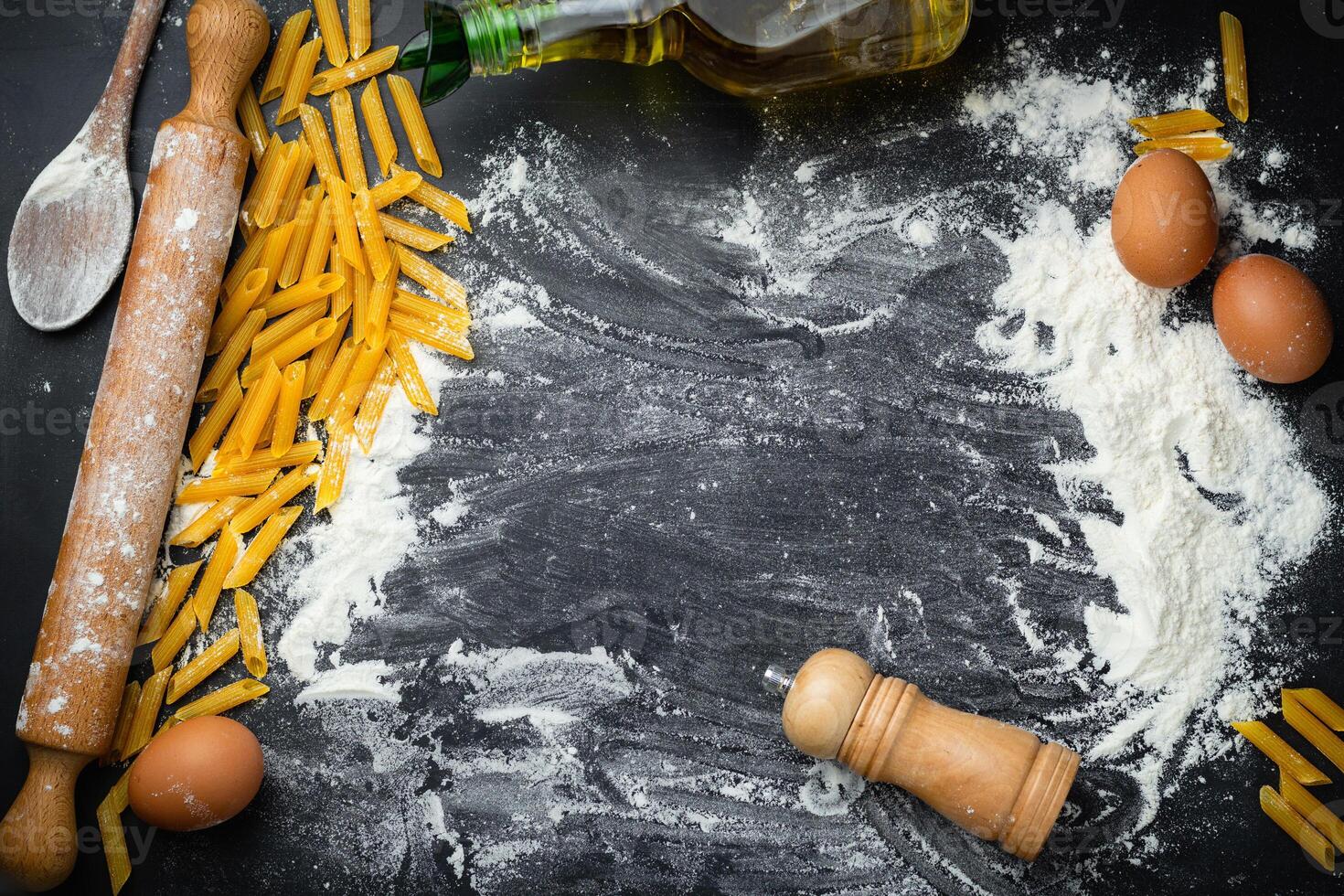 Raw homemade pasta and ingredients for pasta on wooden background. Top view photo