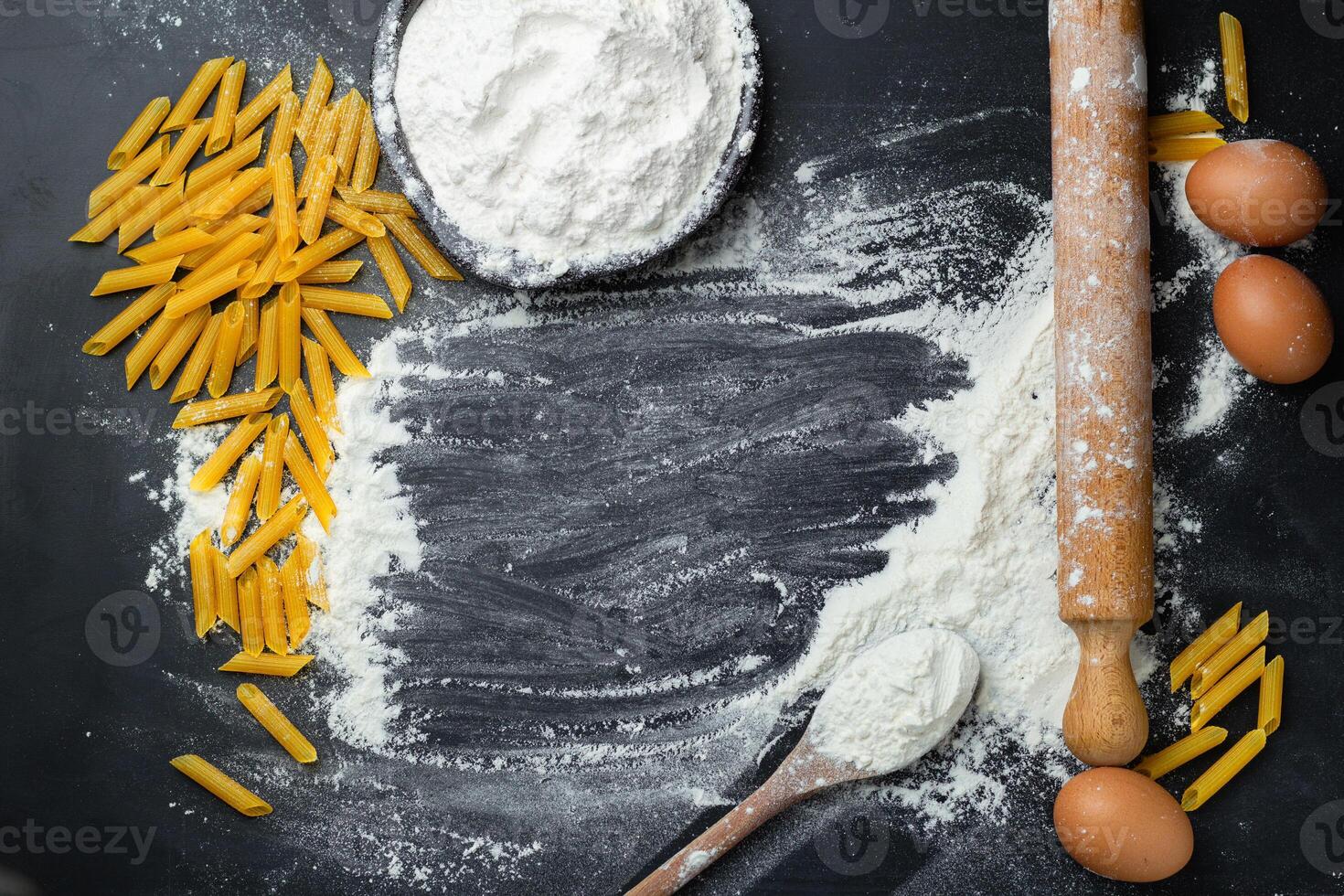 Baking background with egg, pasta, penne and rolling pin. Copy space photo