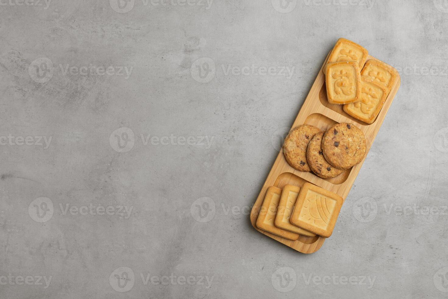 Set of cookies in a plate, gray concrete background. Top view, flat lay, copy space. photo