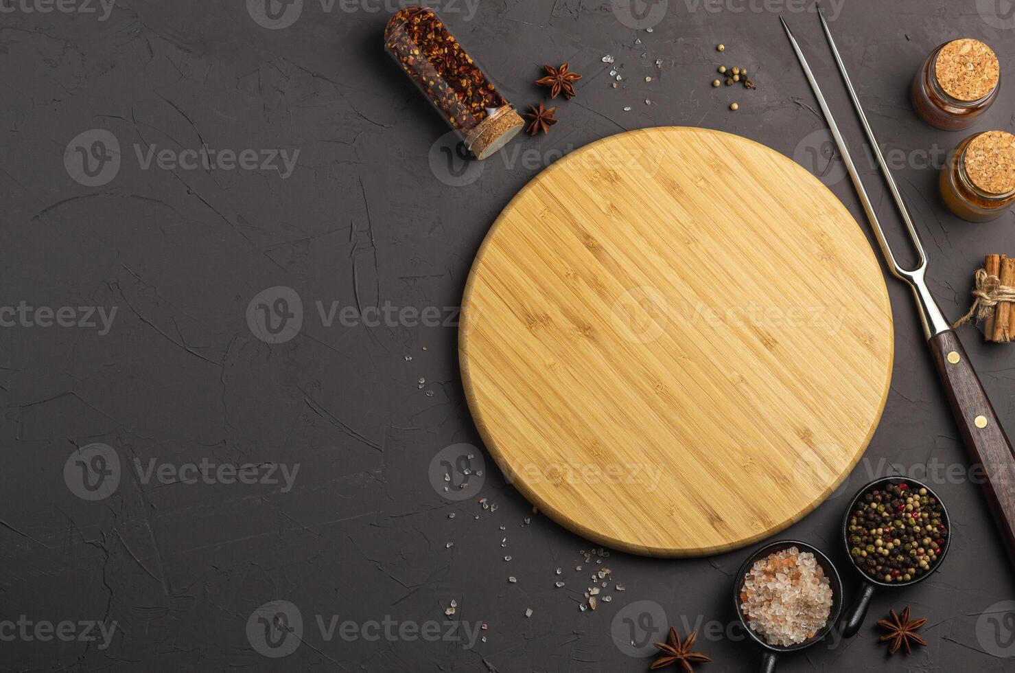 Wooden cooking board with vegetables and spices on a gray concrete background, top view photo