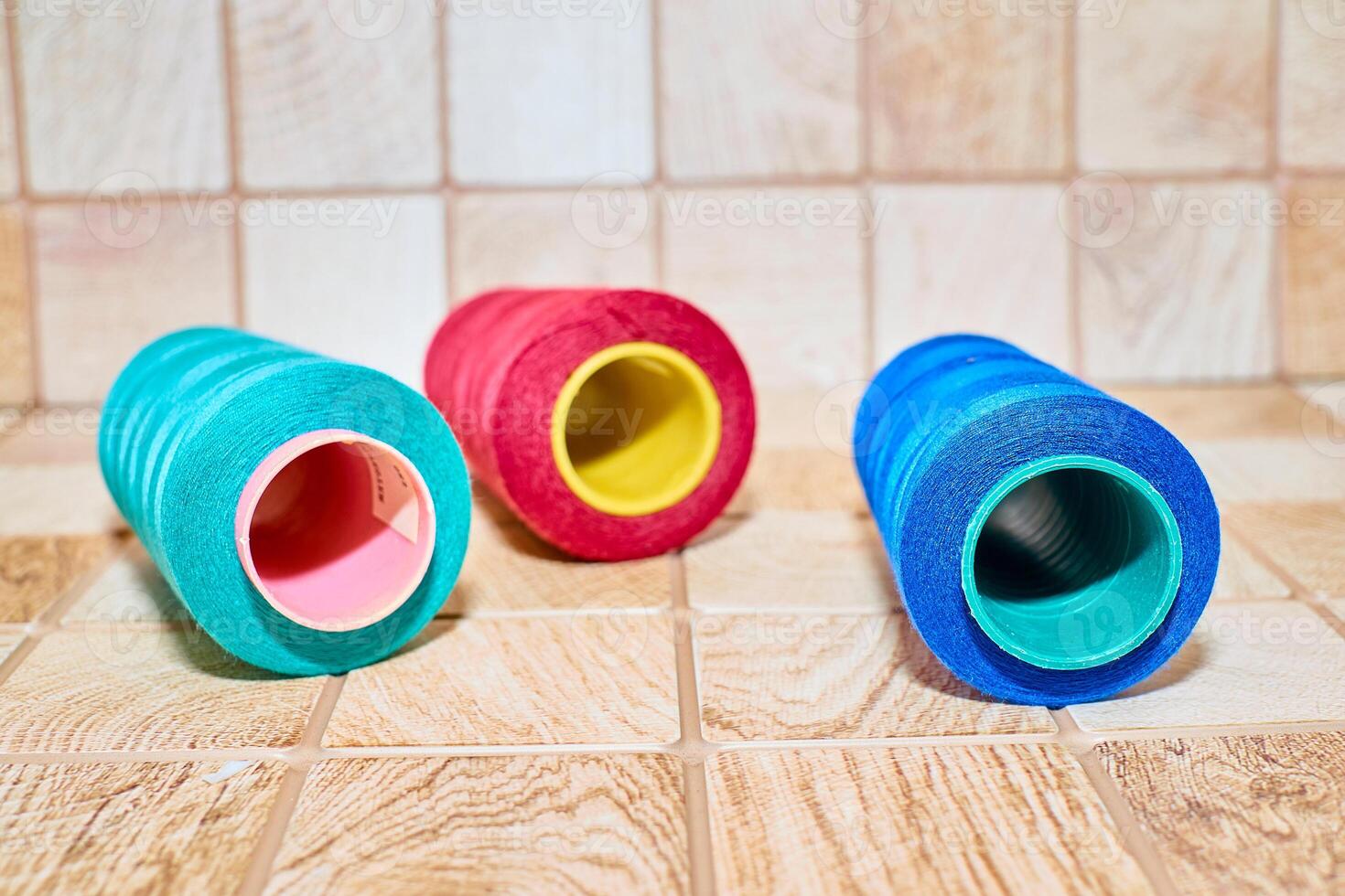 Three spools of thread. Navy, red and blue photo