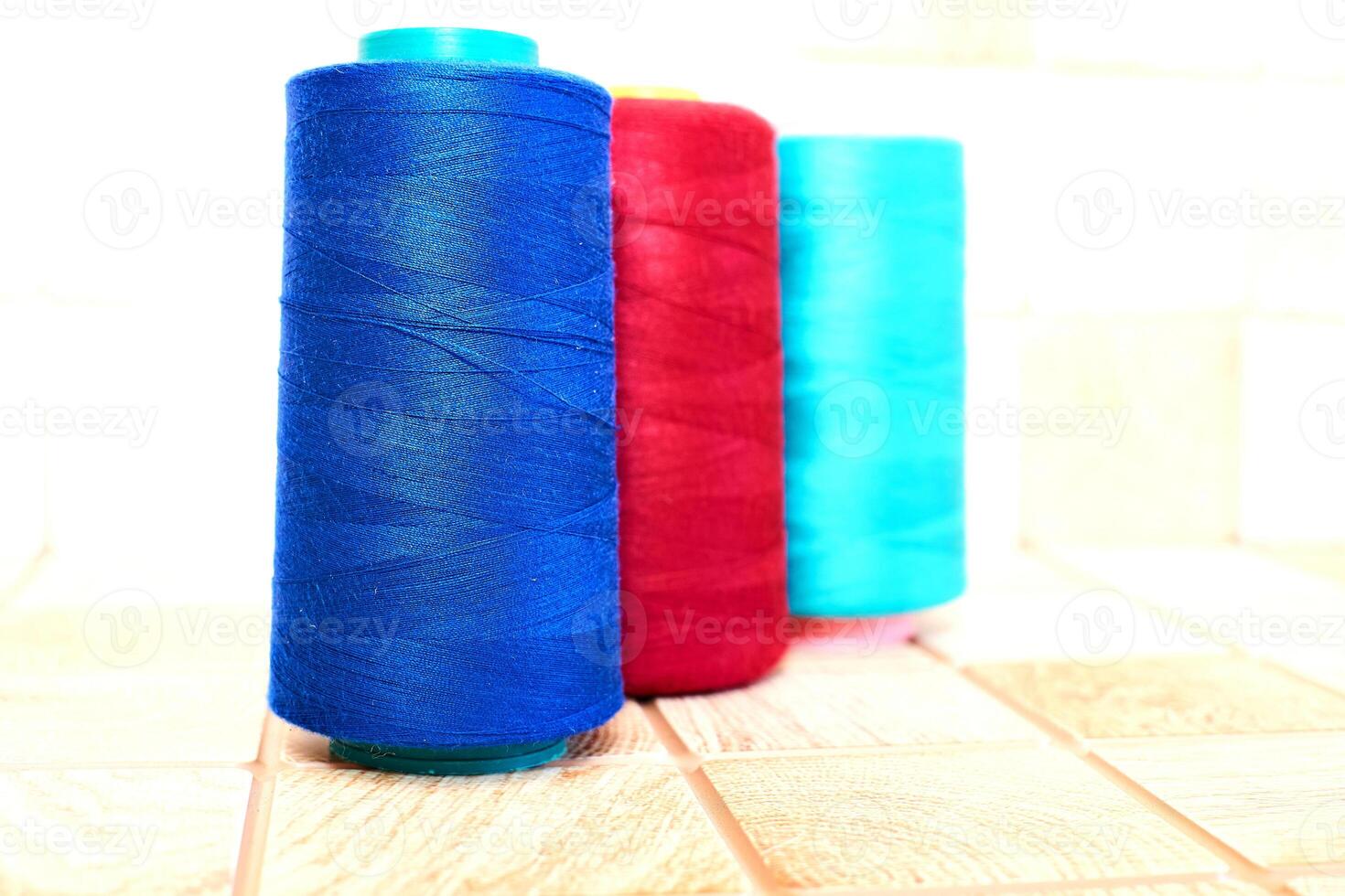 Three spools of thread. Navy, red and blue photo