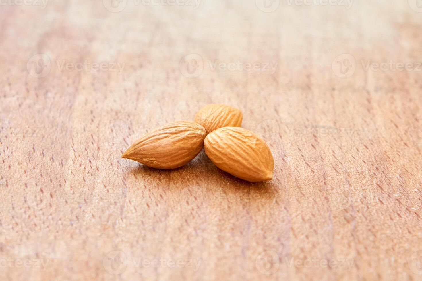 Ripe apricot kernels on wooden, taste of warm summer. photo