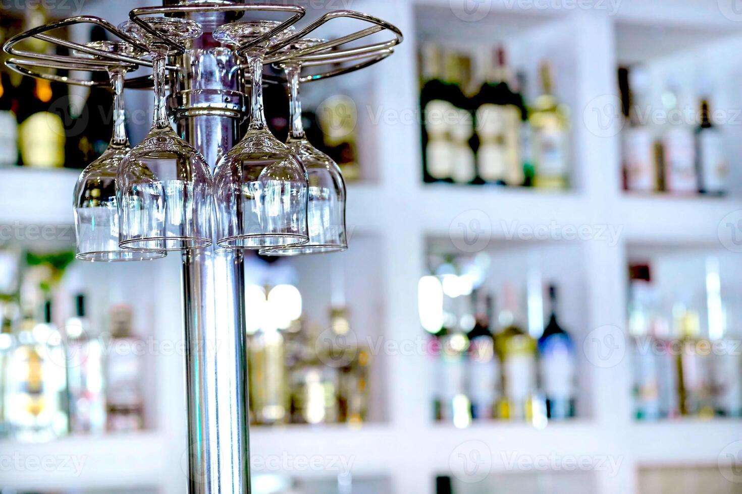 Wine glasses hanging on bar counter in a cafe or restaurant photo