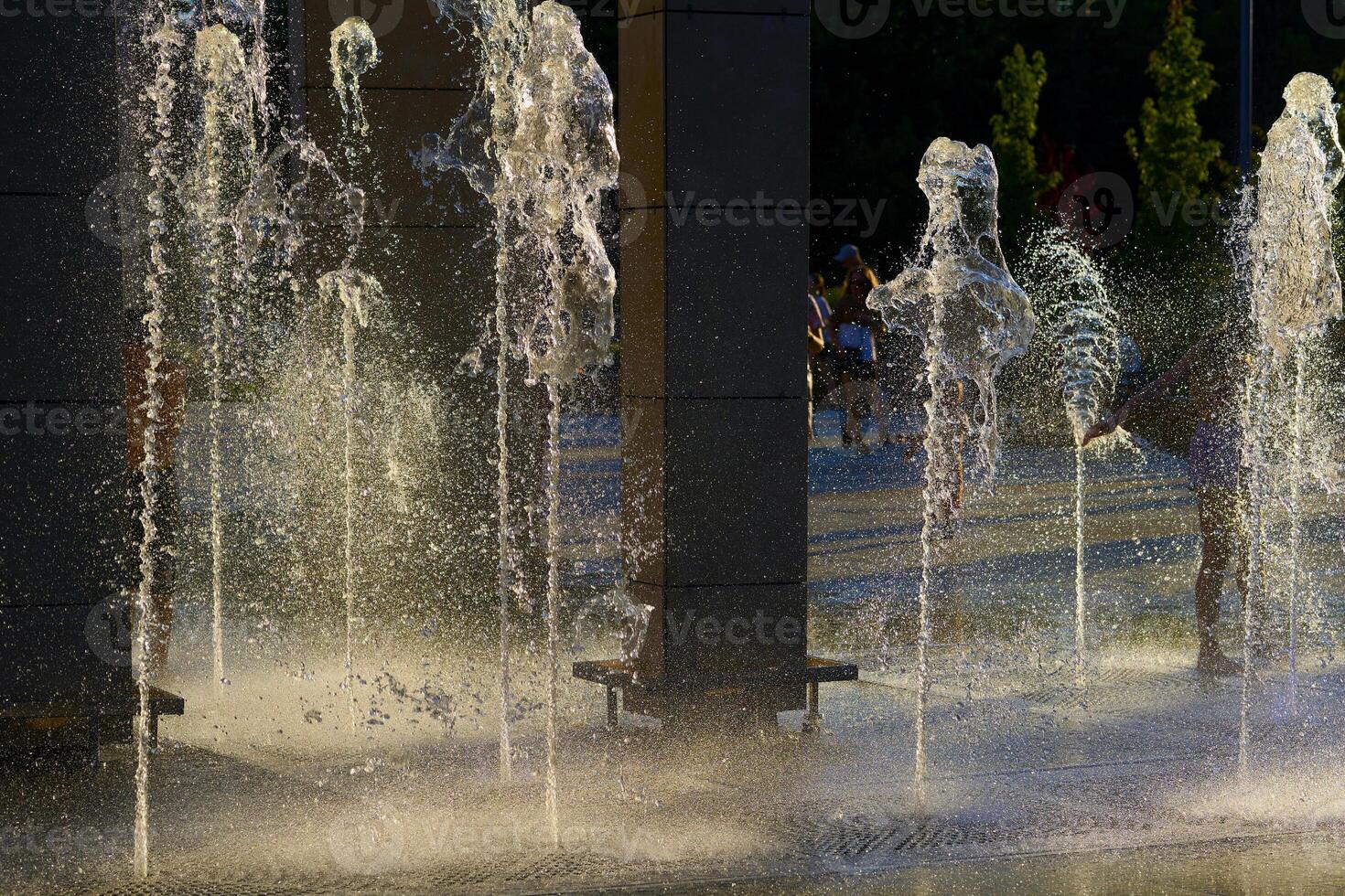 Cool water fountains flow in the summer heat photo