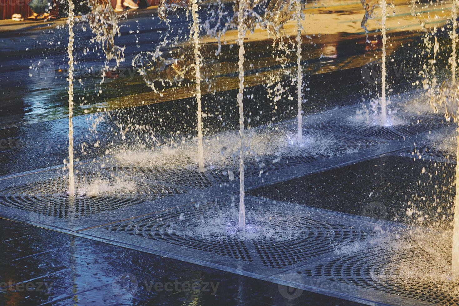 Cool water fountains flow in the summer heat photo