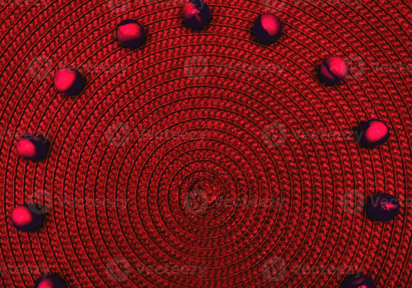 Dark red spiral round straw background with balls. Place for text photo