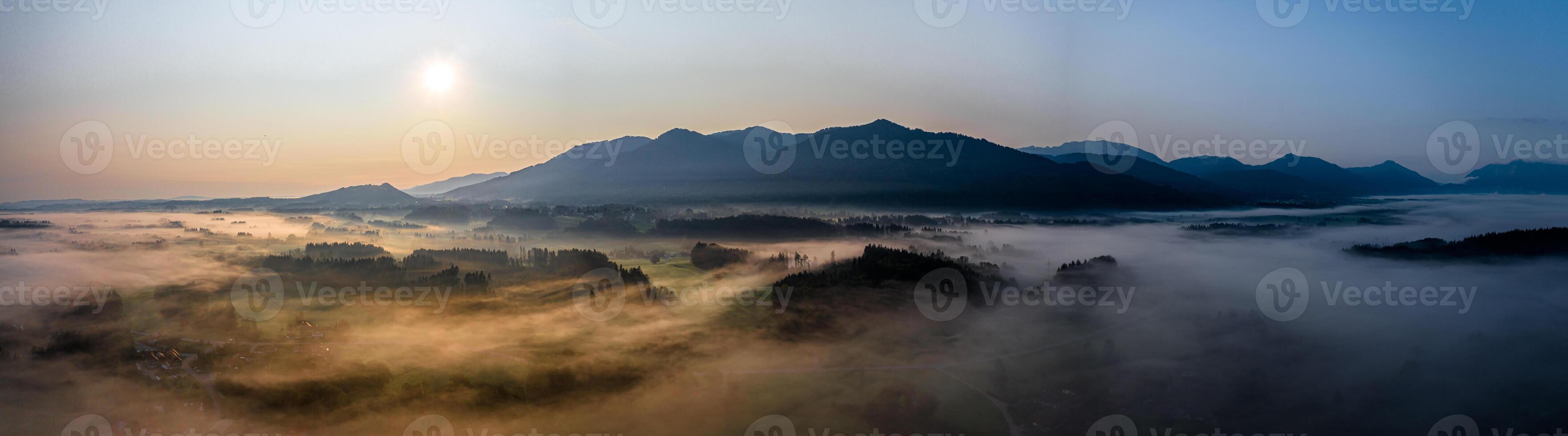 puesta de sol panorama con zumbido a el bávaro Alpes. niebla y niebla a el suelo foto