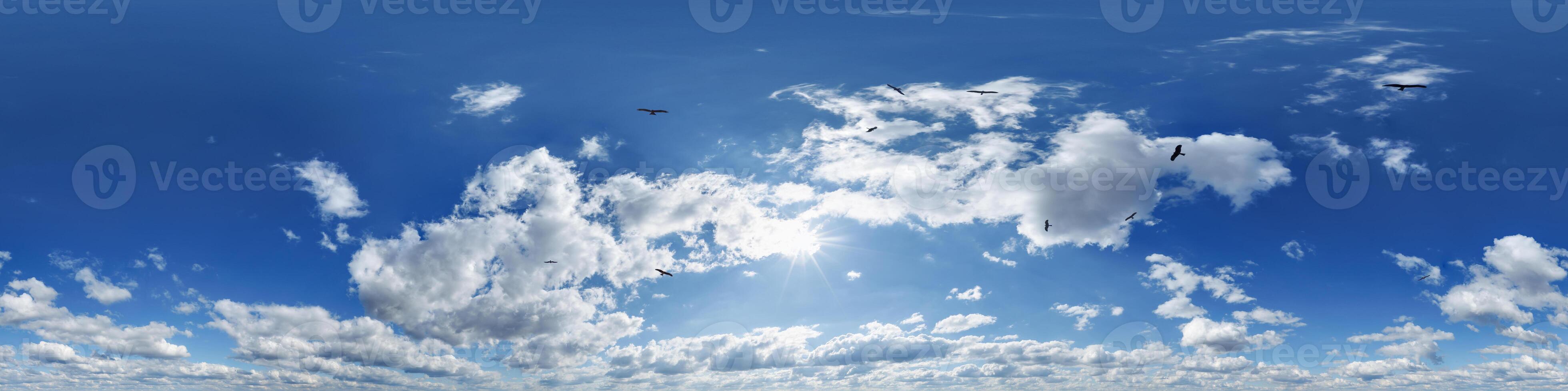 blue skydome with flock of birds in 360 hdri panorama in equirectangular format and clouds and sun for use in 3d graphics or game development as skydome or edit drone shot or sky replacement photo