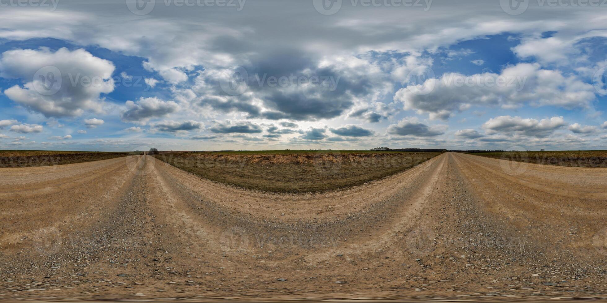 hdri 360 panorama on gravel road among fields in spring nasty day with awesome clouds in equirectangular full seamless spherical projection, for VR AR virtual reality content photo