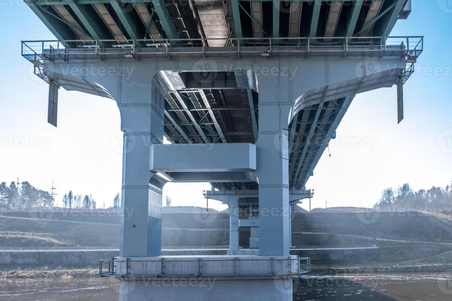 steel frame and concrete construction huge car bridge across the wide river. photo