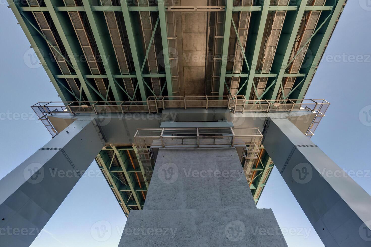 steel frame and concrete construction huge car bridge across the wide river. photo