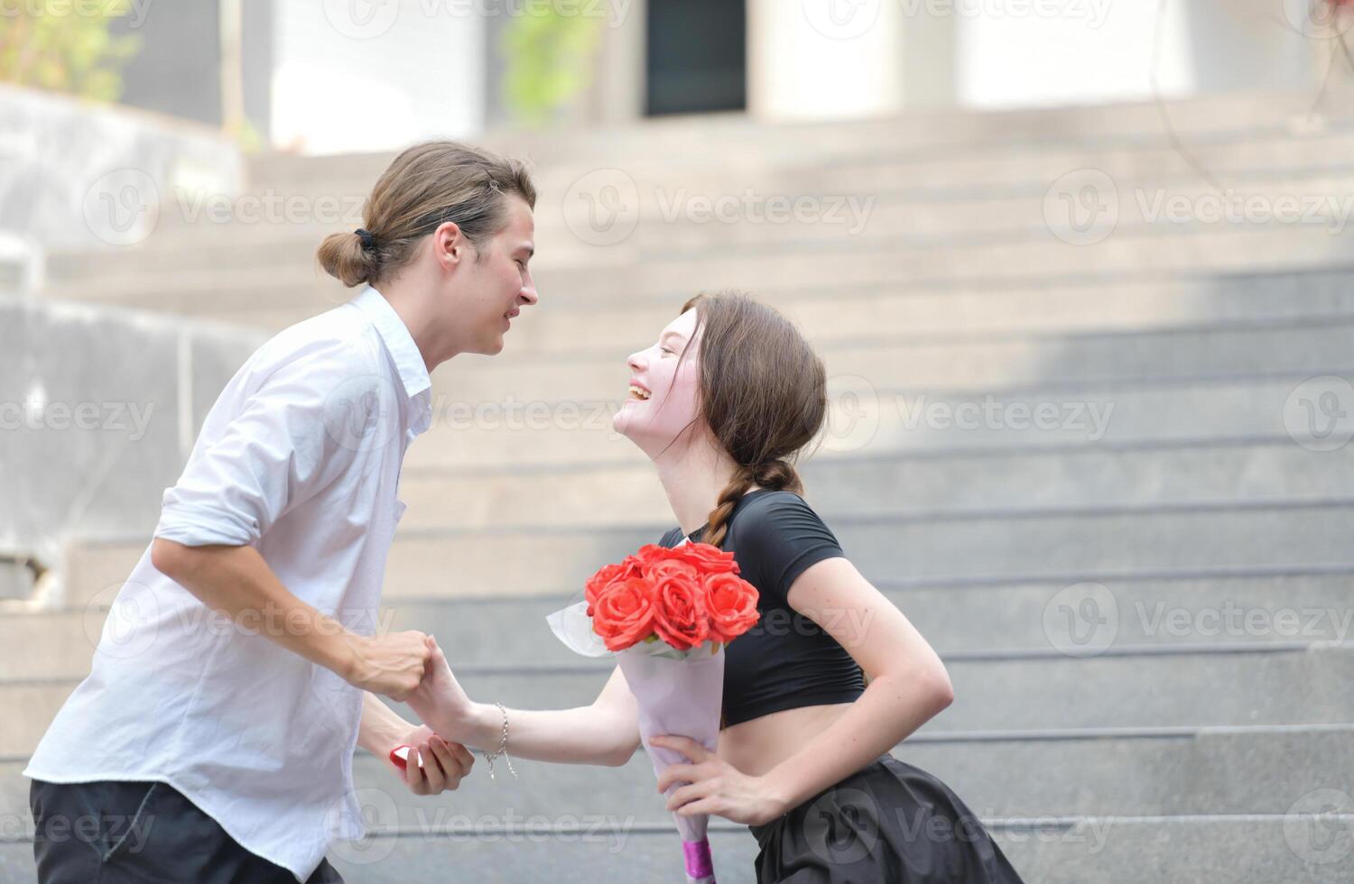 A couple is enjoying a summer vacation in the community area, happily showing their love to each other. photo