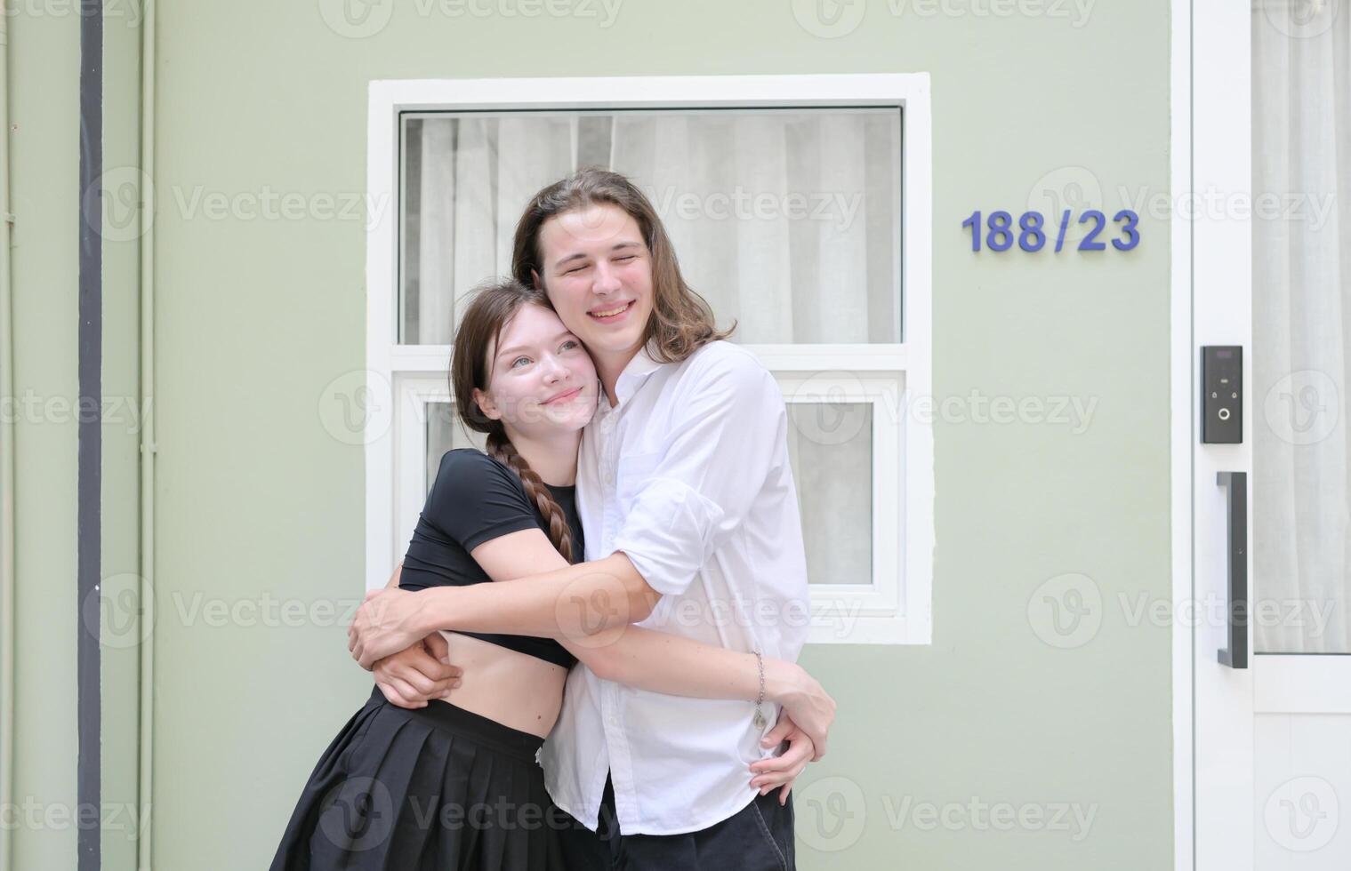 A couple is enjoying a summer vacation in the community area, happily showing their love to each other. photo