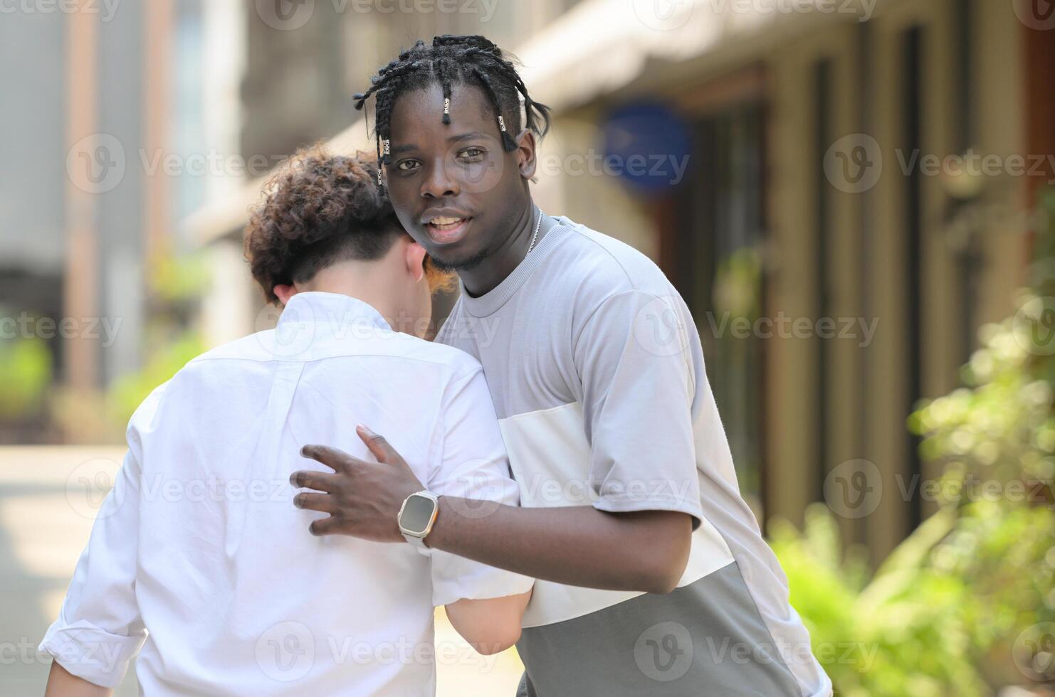 Young multiethnic friend having fun outdoors on beautiful summer day photo