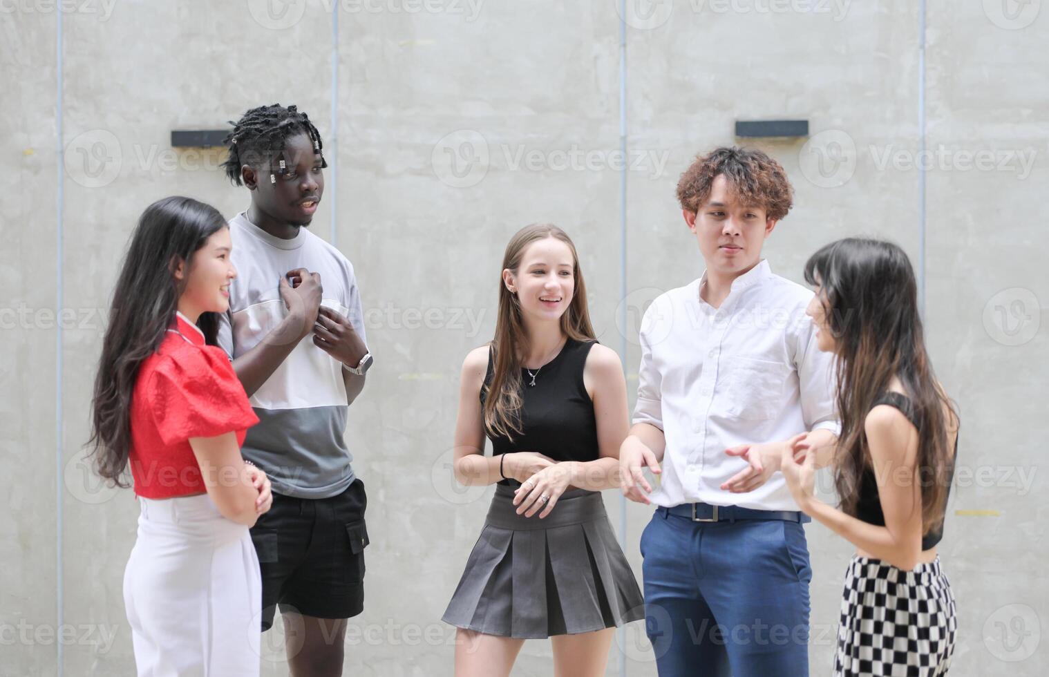 Group of young multiethnic friend having fun and laughing outdoors on beautiful summer day photo