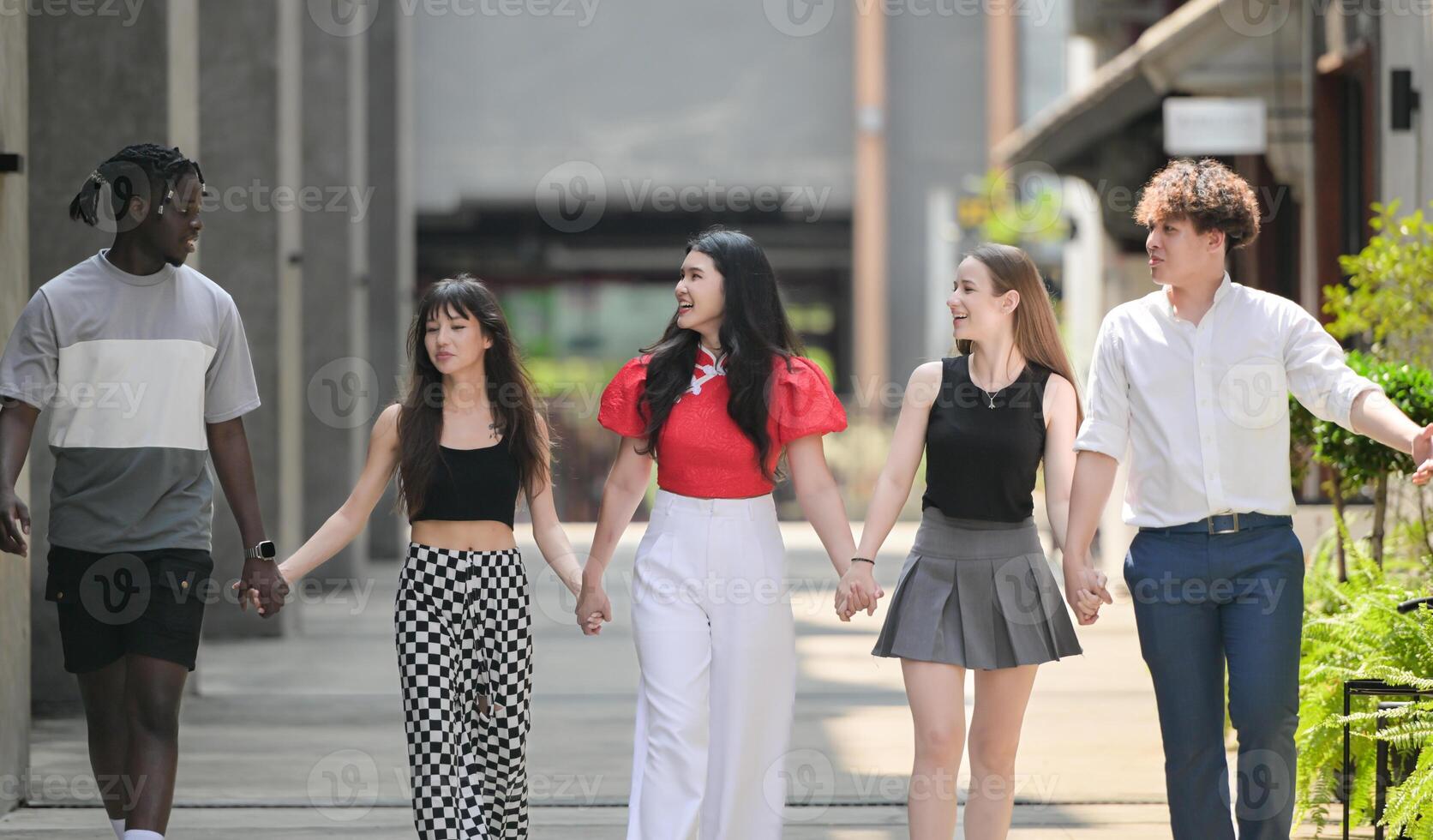 Group of young multiethnic friend having fun and laughing outdoors on beautiful summer day photo