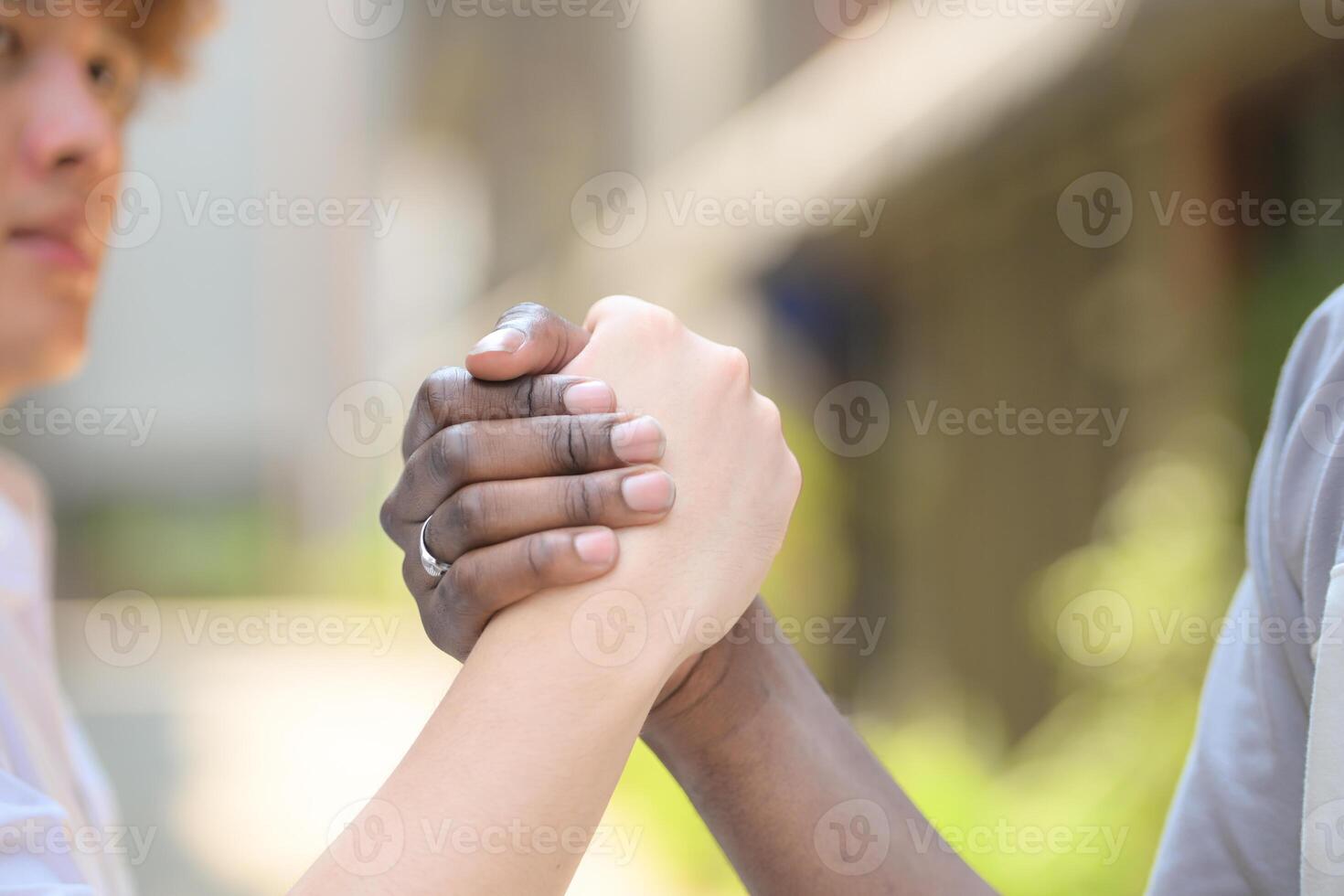 Close-up of the hands of an African man and an Asian man. photo