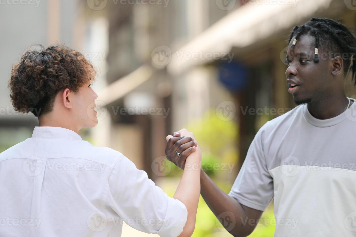 Young multiethnic friend having fun outdoors on beautiful summer day photo