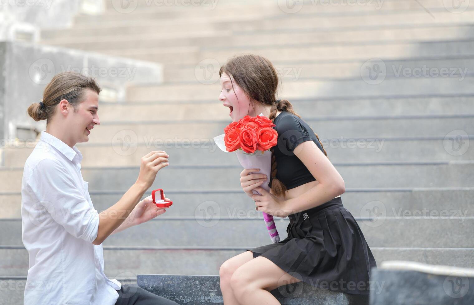 A couple is enjoying a summer vacation in the community area, happily showing their love to each other. photo