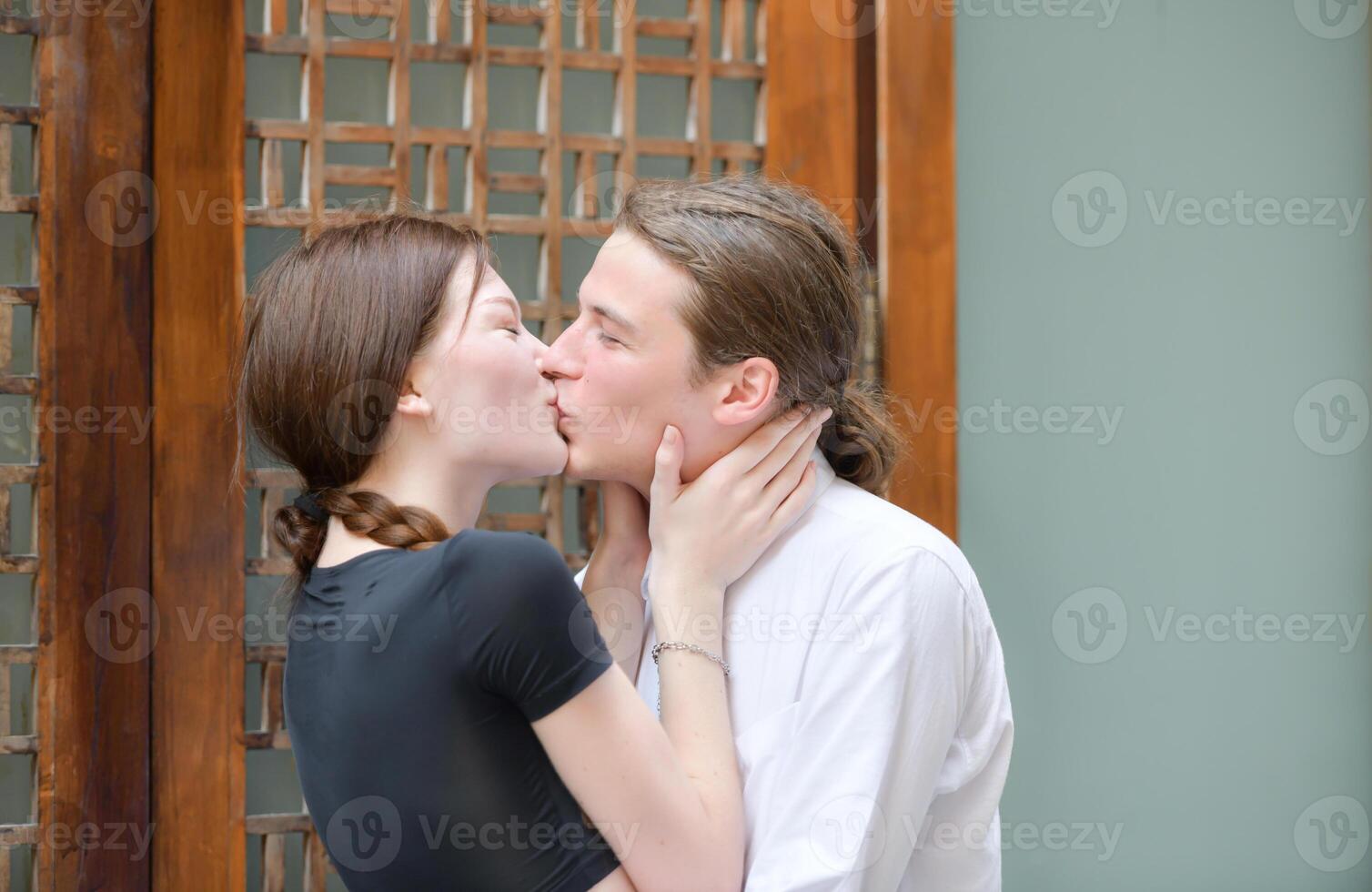 A couple is enjoying a summer vacation in the community streets, happily showing their love to each other. photo