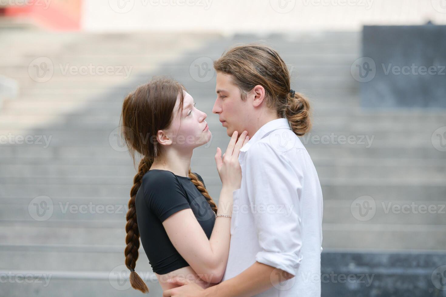 A couple is enjoying a summer vacation in the community area, happily showing their love to each other. photo