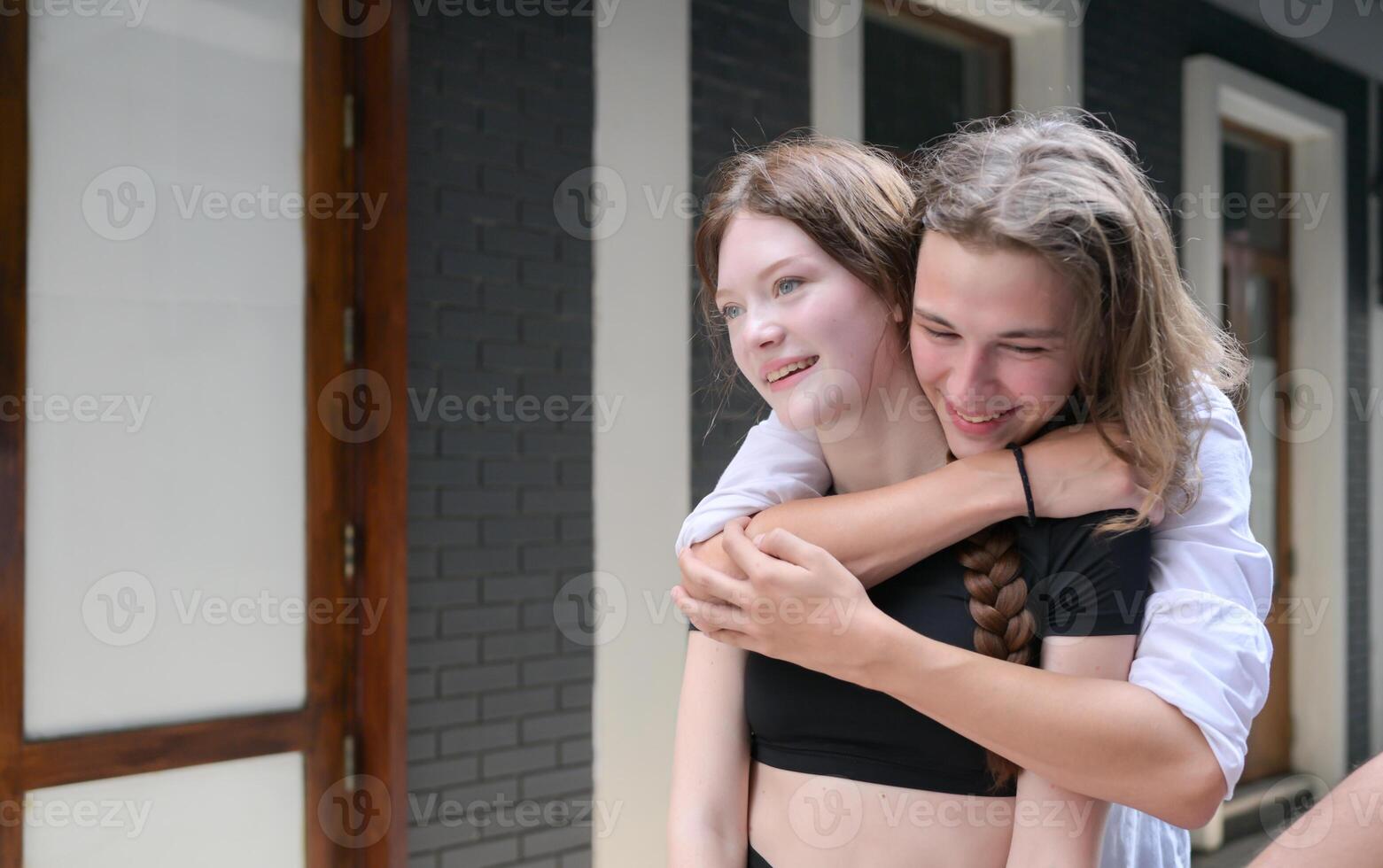 A couple is enjoying a summer vacation in the community streets, happily showing their love to each other. photo