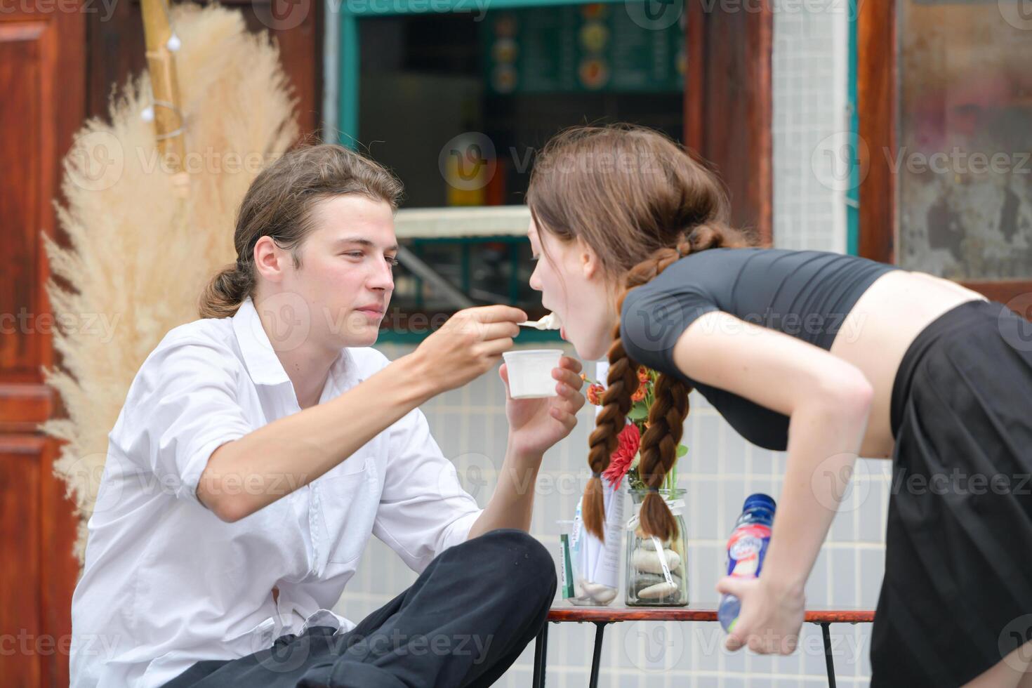 A couple is enjoying a summer vacation in the community area, happily showing their love to each other. photo