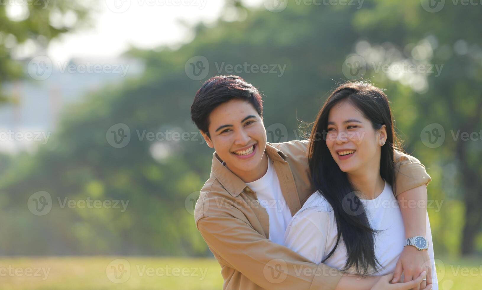 LGBT couple is enjoying a summer vacation in the park, happily showing their love to each other. photo