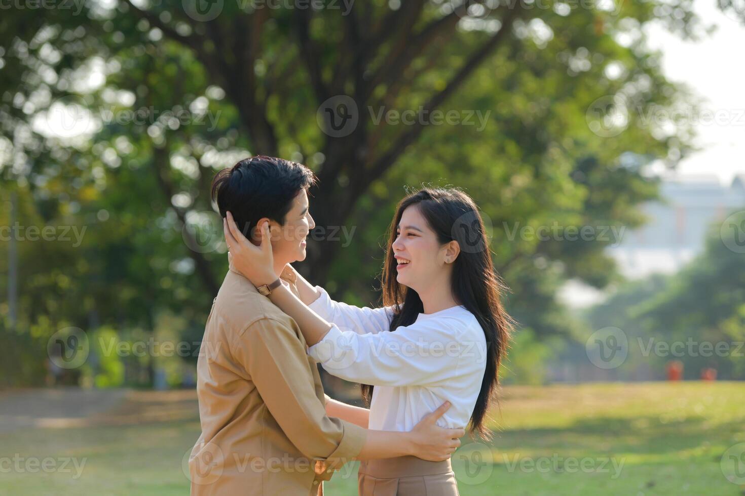 LGBT couple is enjoying a summer vacation in the park, happily showing their love to each other. photo