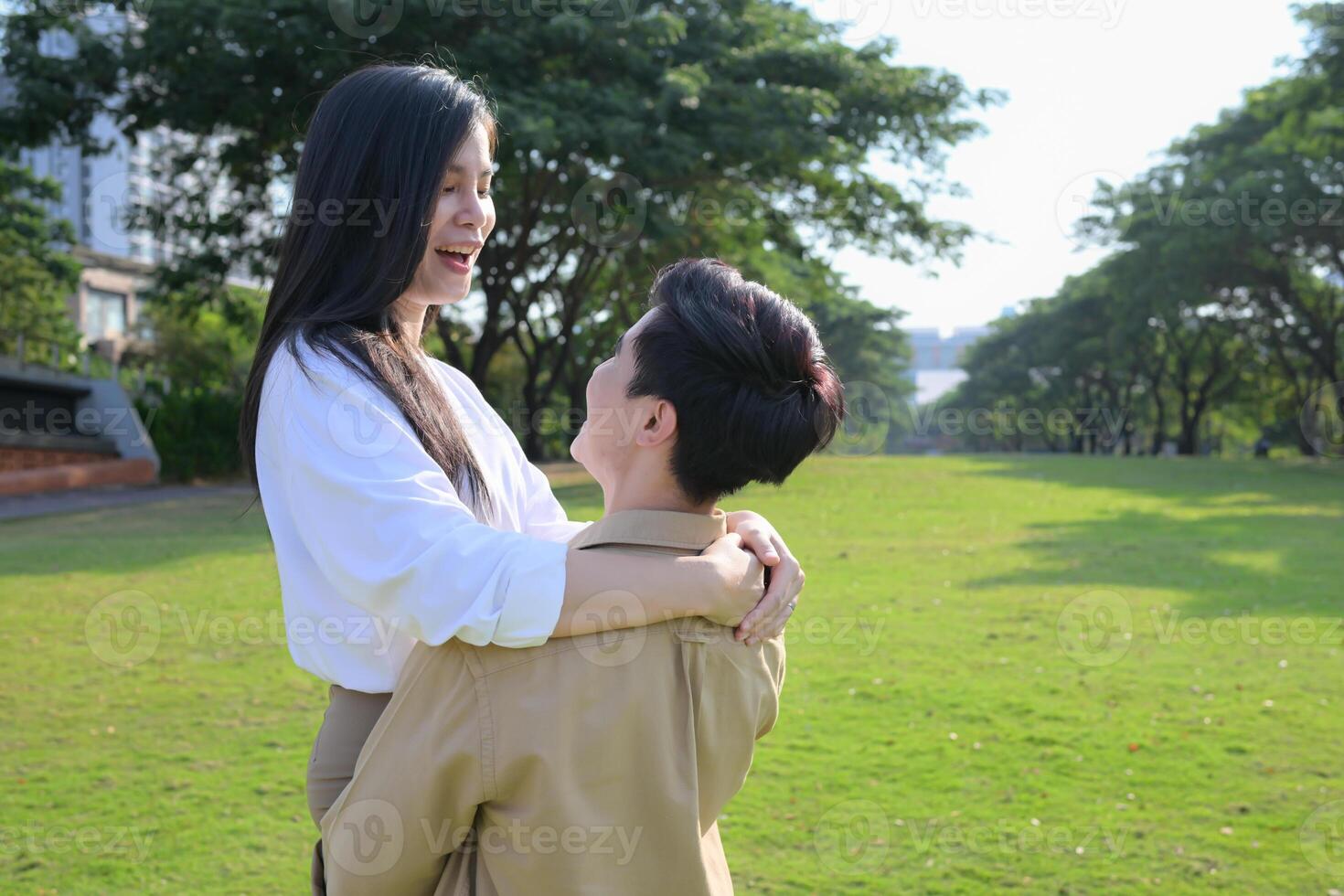 LGBT couple is enjoying a summer vacation in the park, happily showing their love to each other. photo
