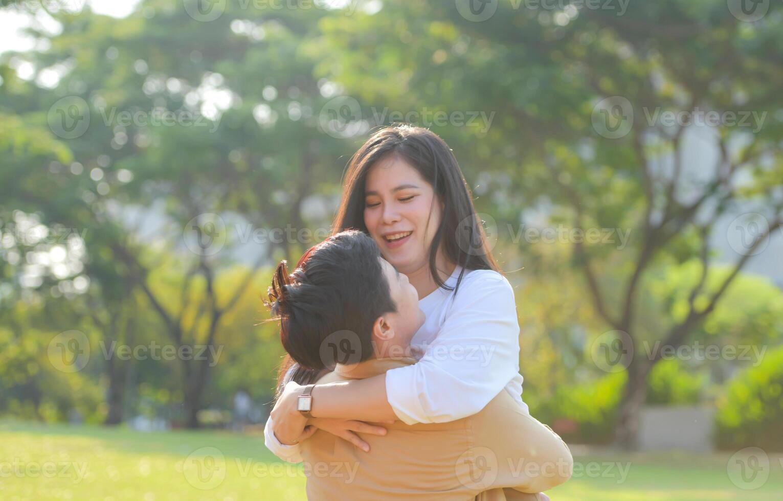 LGBT couple is enjoying a summer vacation in the park, happily showing their love to each other. photo