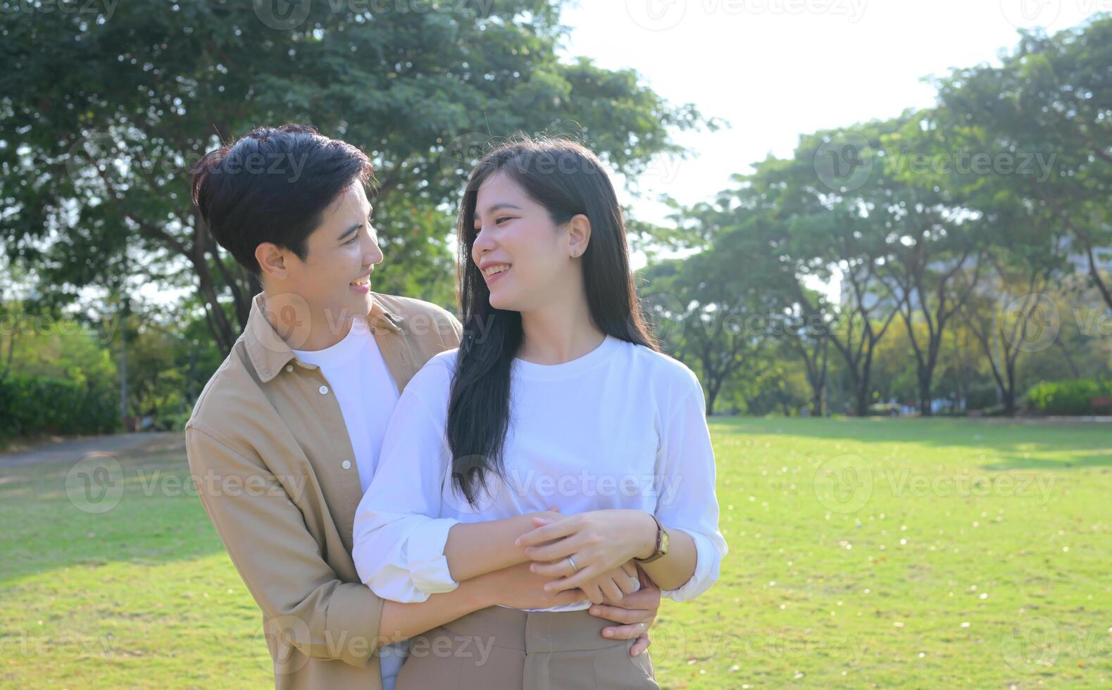 LGBT couple is enjoying a summer vacation in the park, happily showing their love to each other. photo