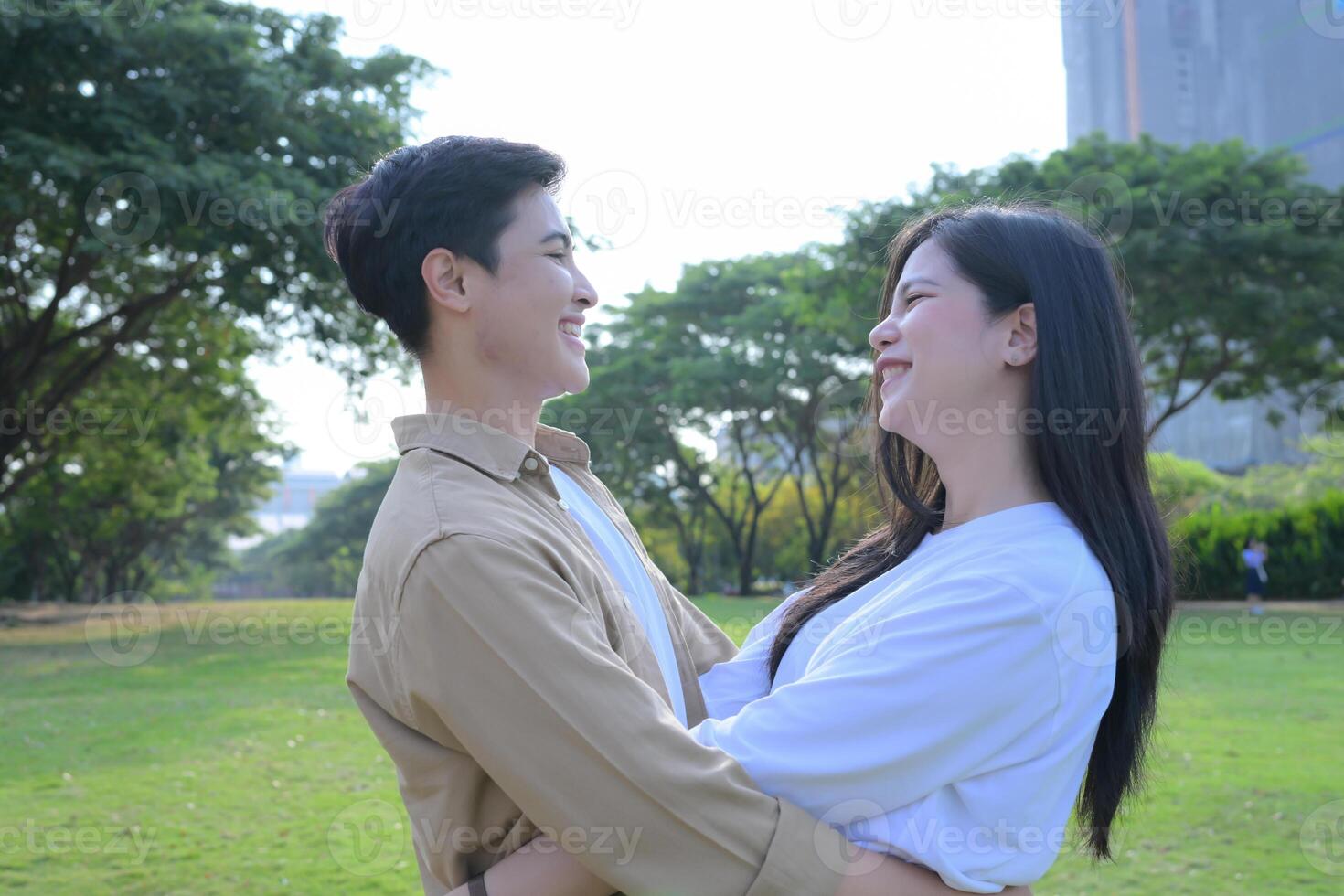 LGBT couple is enjoying a summer vacation in the park, happily showing their love to each other. photo