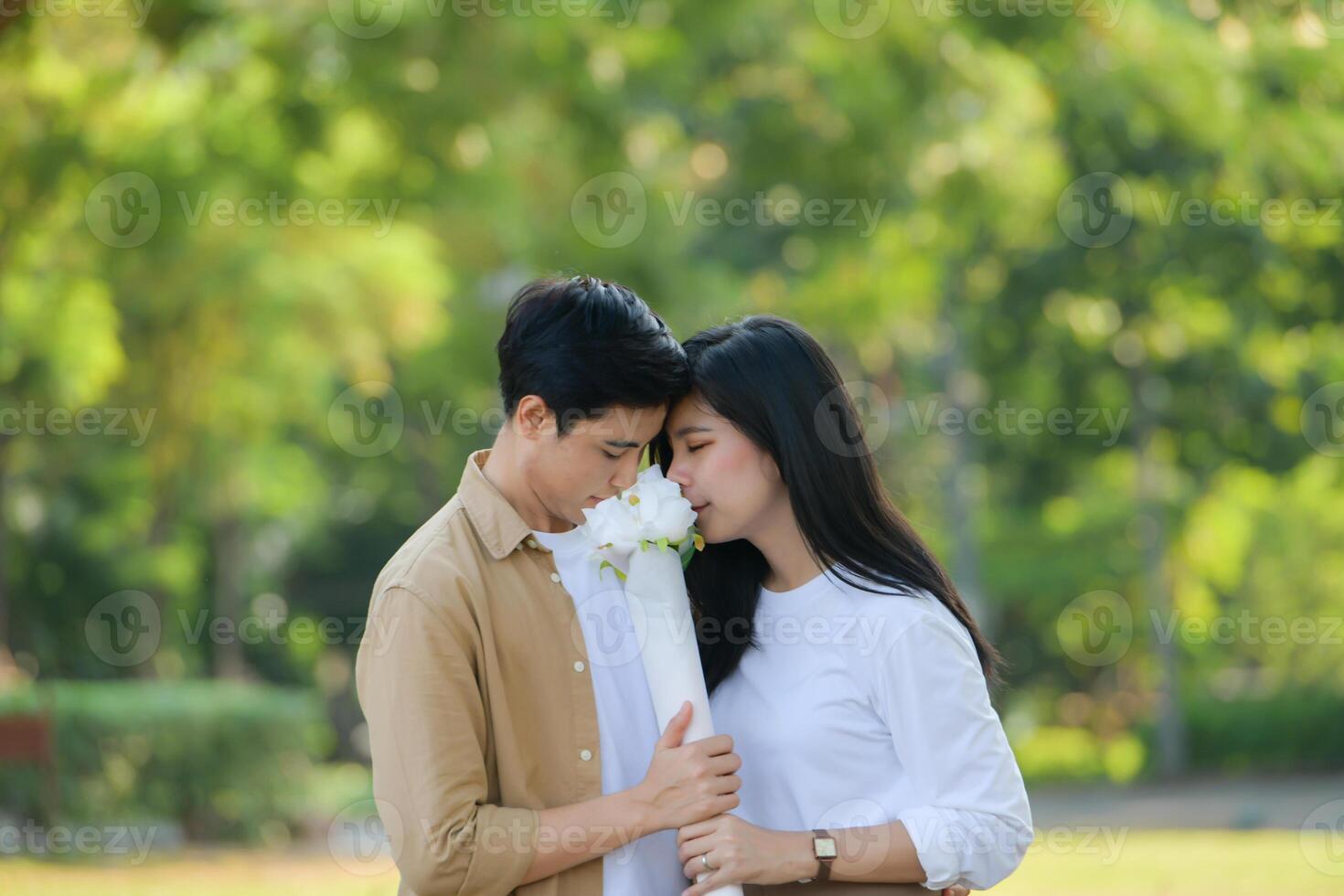 LGBT couple is enjoying a summer vacation in the park, happily showing their love to each other. photo