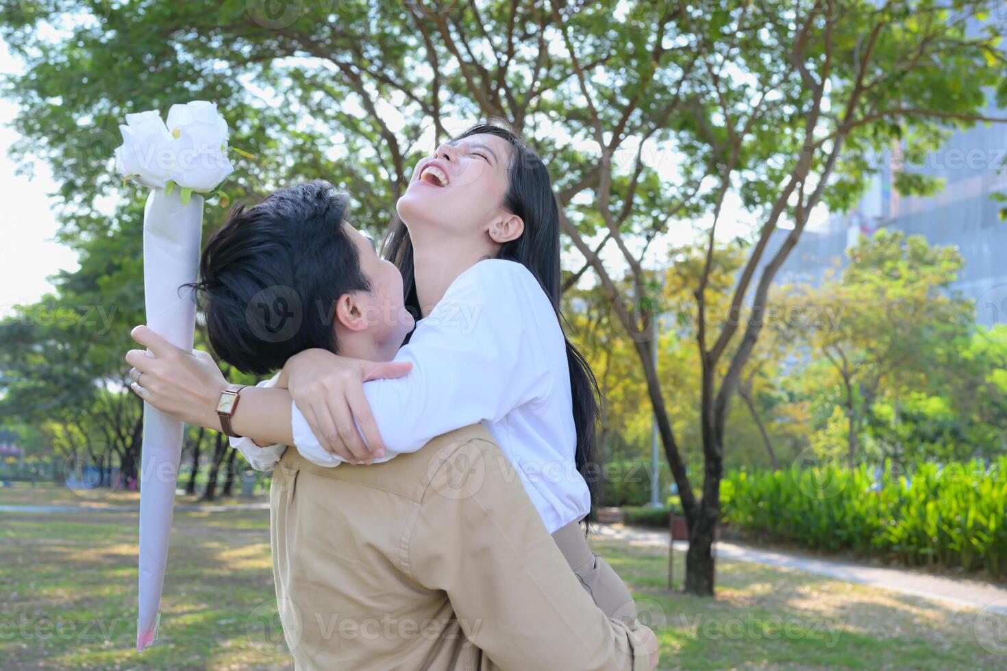 LGBT couple is enjoying a summer vacation in the park, happily showing their love to each other. photo