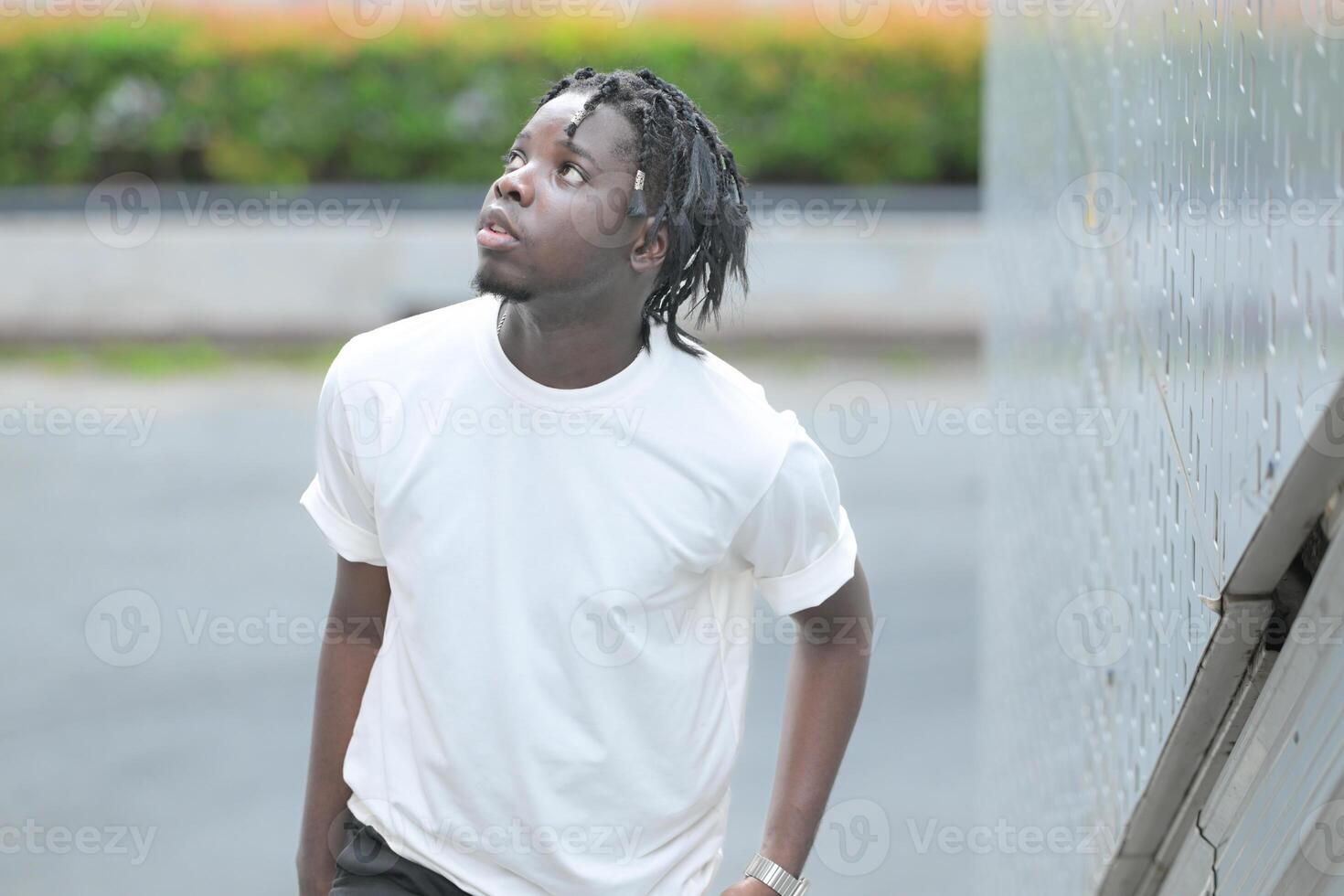 A young man with his hairstyle and the atmosphere of living in the community. photo