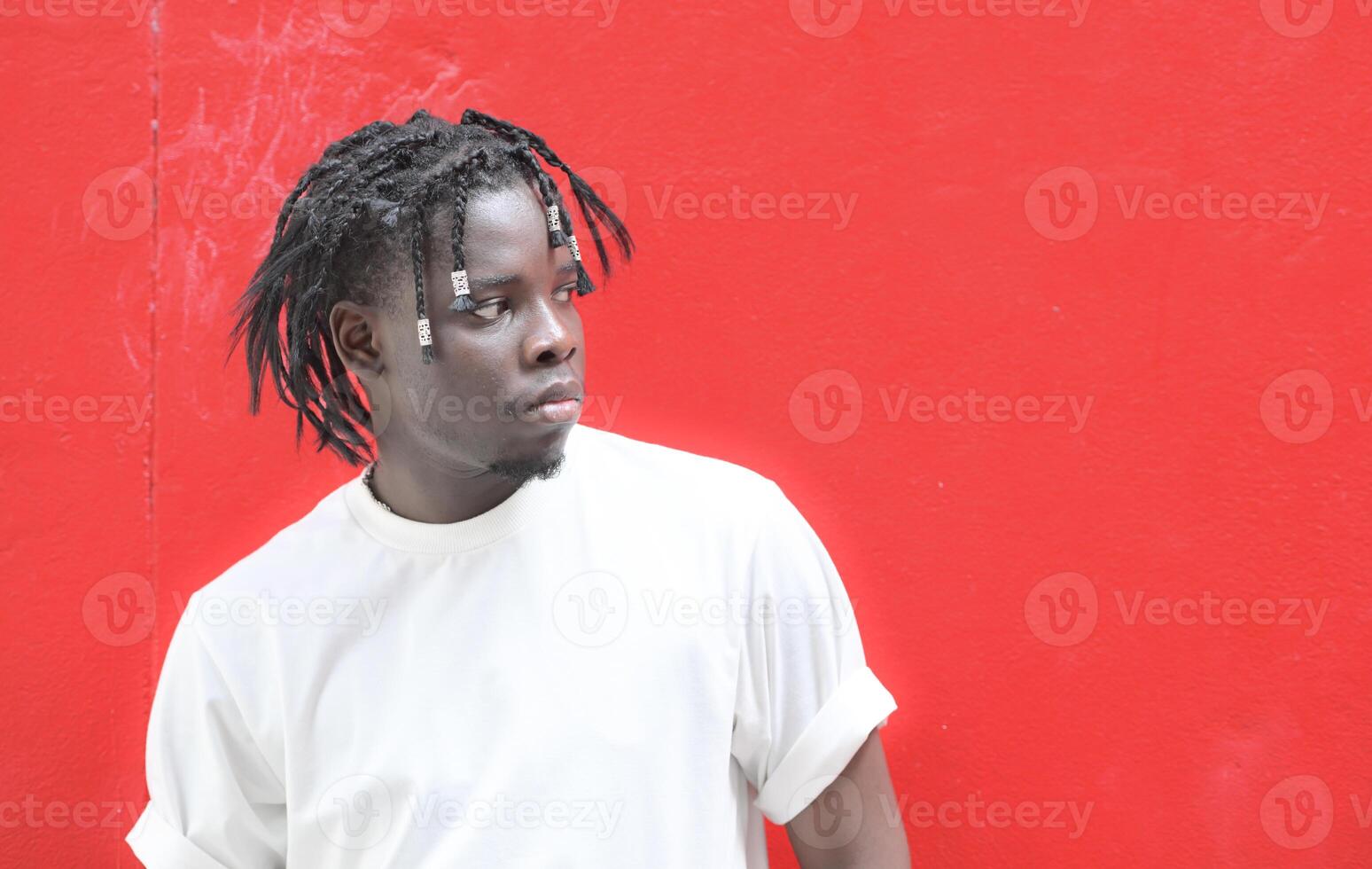 A young man with his hairstyle and the atmosphere of living in the community. photo