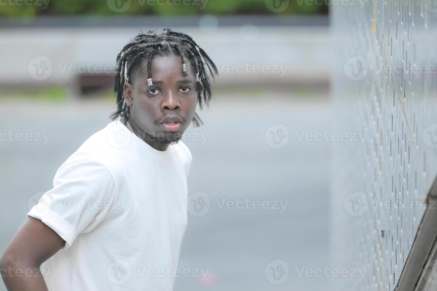 A young man with his hairstyle and the atmosphere of living in the community. photo