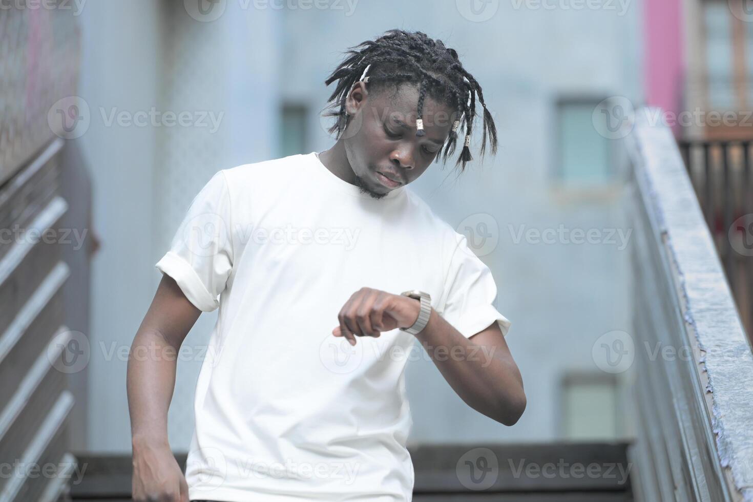 A young man with his hairstyle and the atmosphere of living in the community. photo