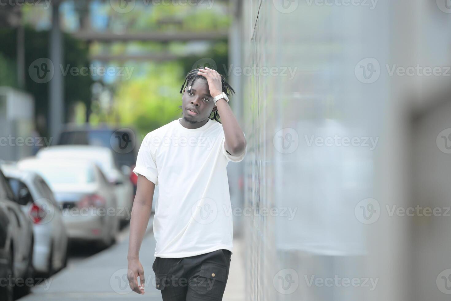 A young man with his hairstyle and the atmosphere of living in the community. photo