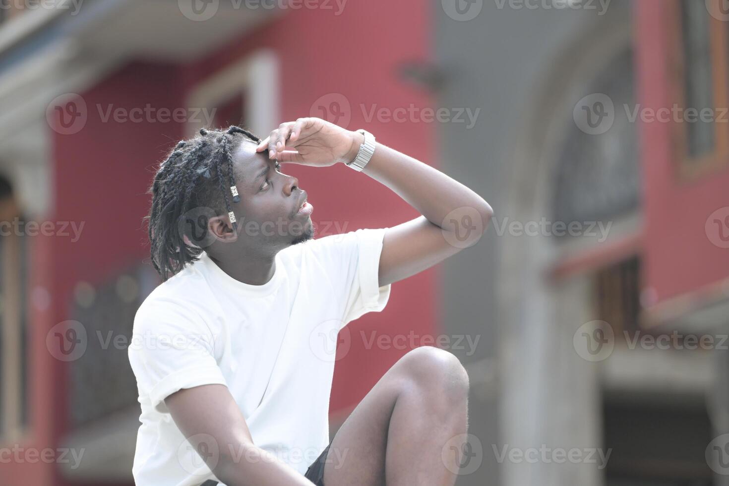 A young man with his hairstyle and the atmosphere of living in the community. photo